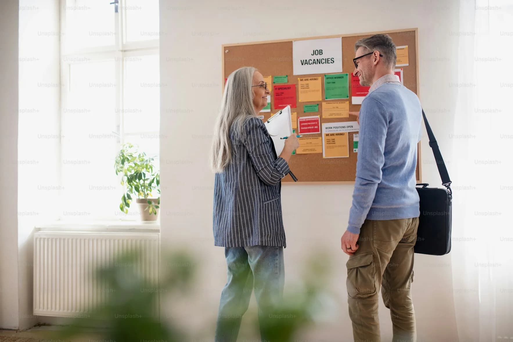 Recruiters preparing a job advertisement on a planning board