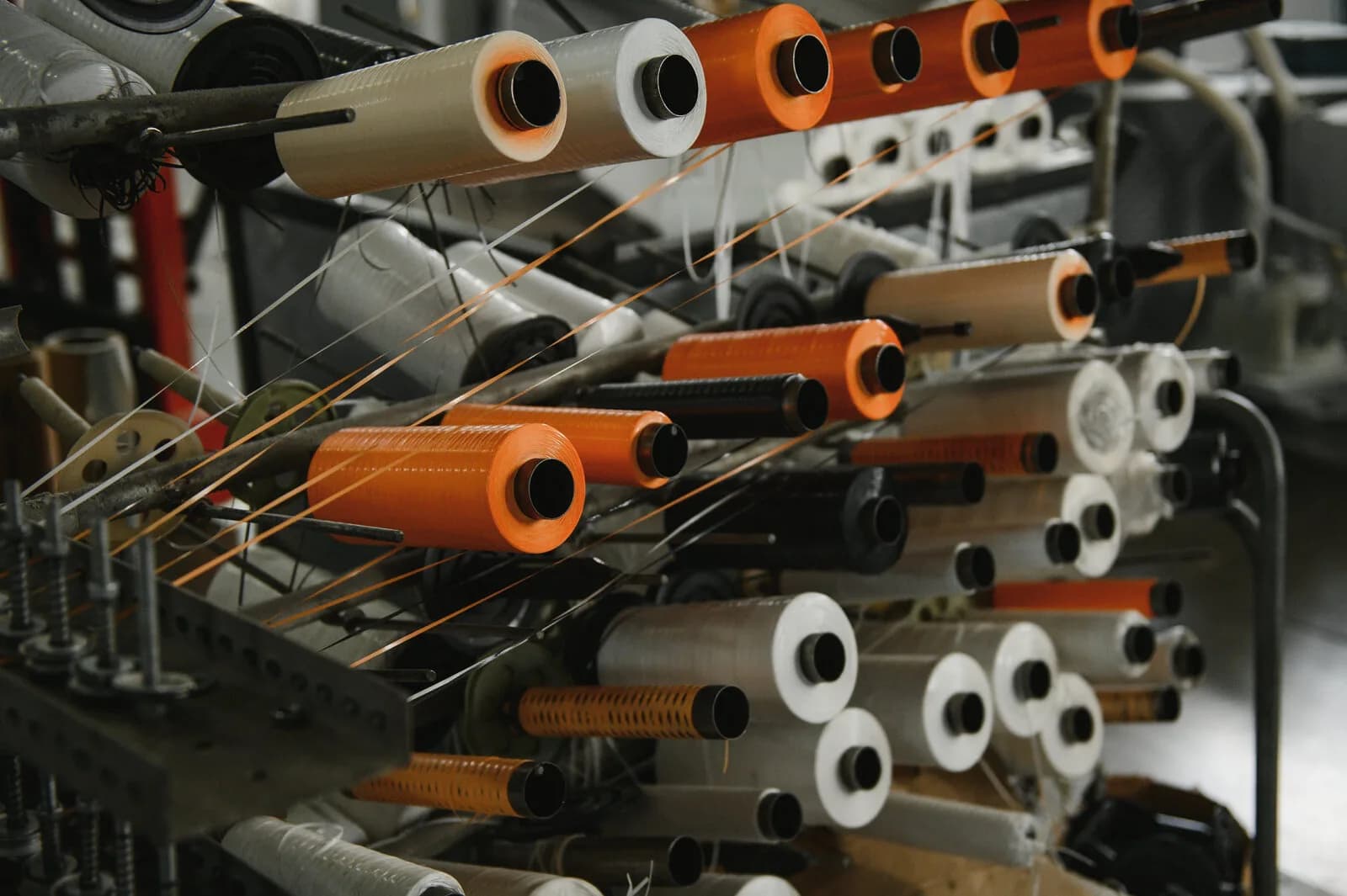Industrial textile production line with weaving spools