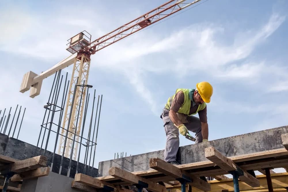 Skilled construction worker preparing structural formwork