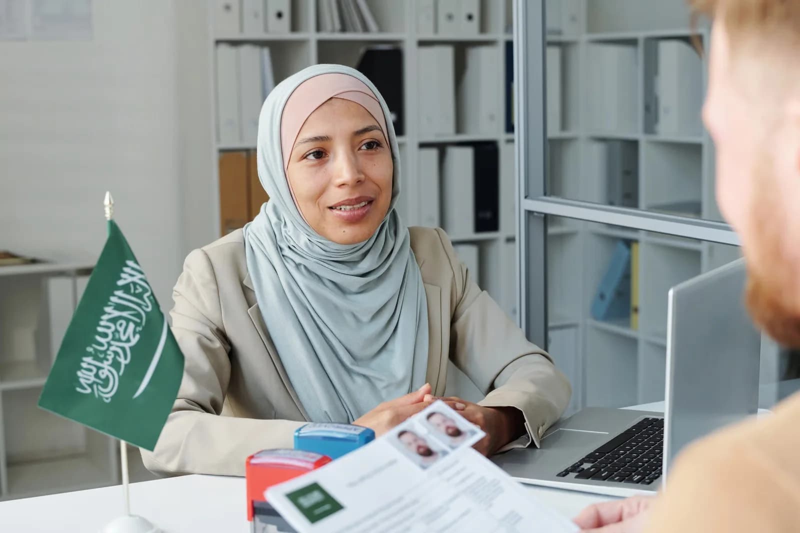 Saudi recruitment consultant discussing candidate documentation