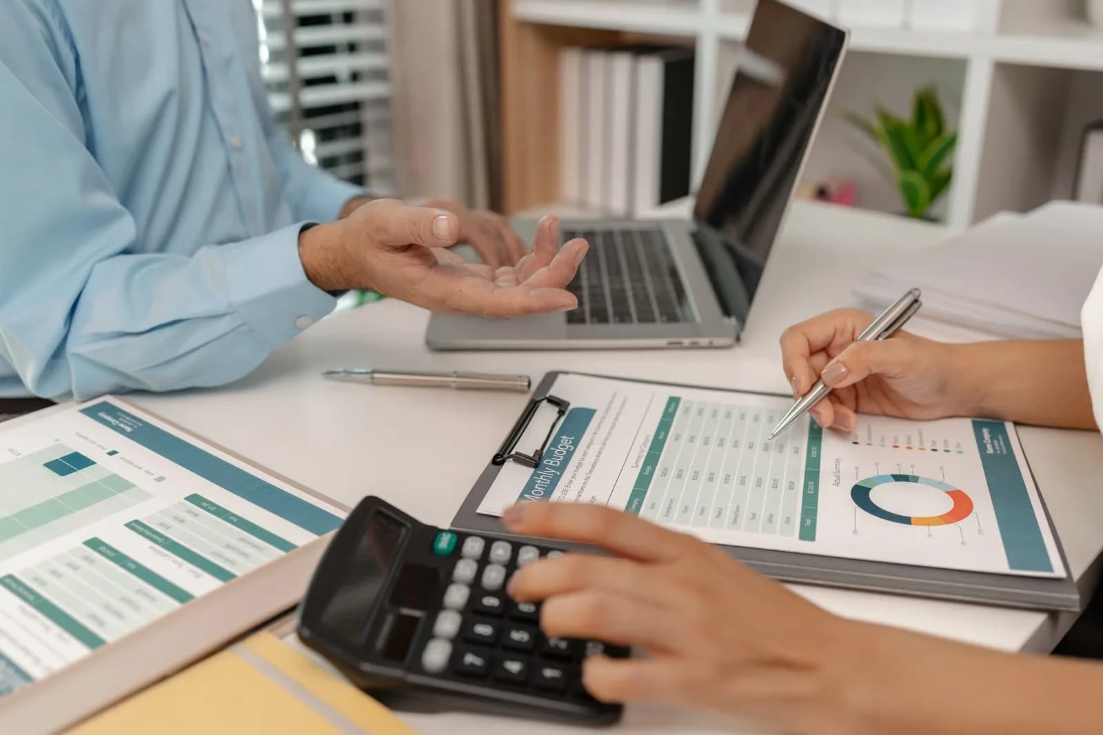 Payroll specialists reviewing an adaptable monthly budget